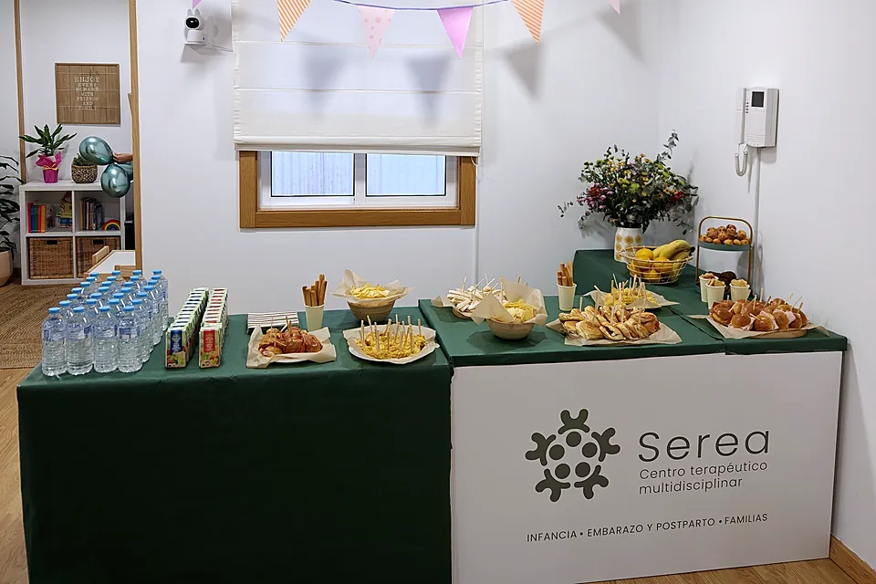 Mesa de merienda con el logotipo de Serea y banderines de fiesta